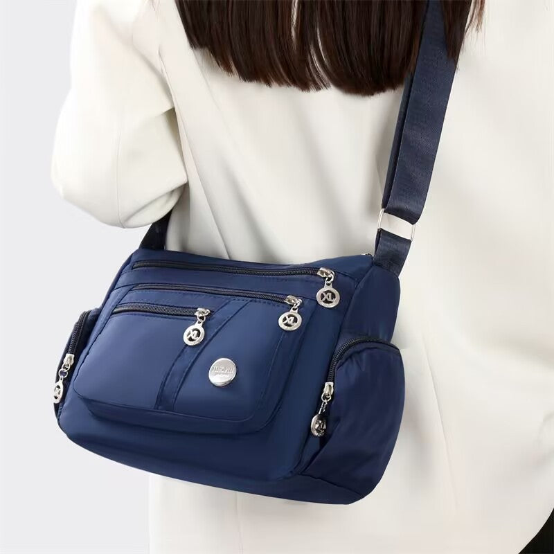 Stylish Multi-Pocket Shoulder Bag for Women, Lightweight and Spacious Design with Zippered Compartments and Fashionable Charm Details